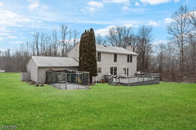 back of house with a deck and a yard