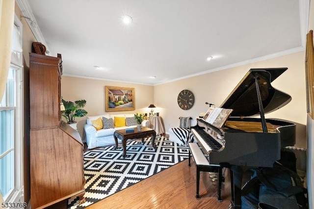 sitting room with hardwood / wood-style floors and ornamental molding