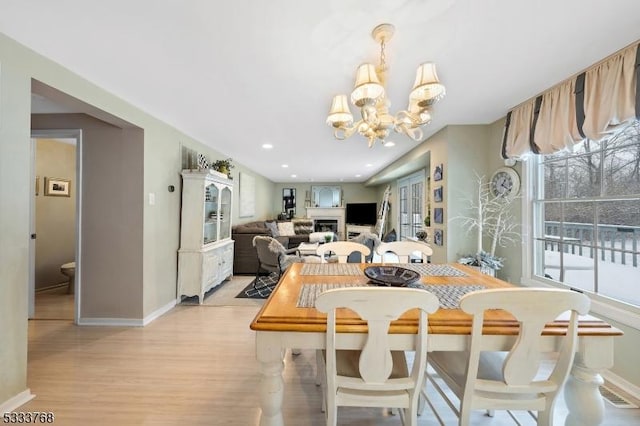 dining room featuring a chandelier and light hardwood / wood-style flooring