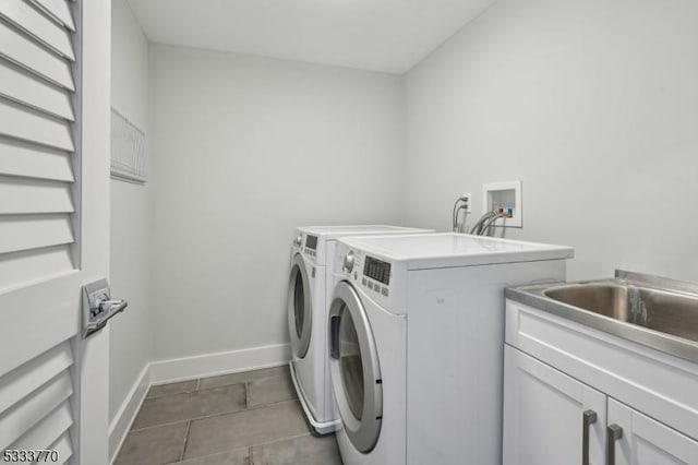 washroom with cabinets and washing machine and dryer