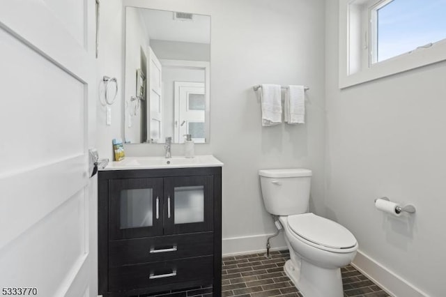 bathroom featuring toilet and vanity