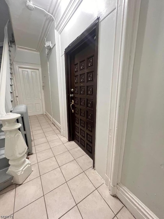 bathroom featuring ornamental molding and tile patterned flooring