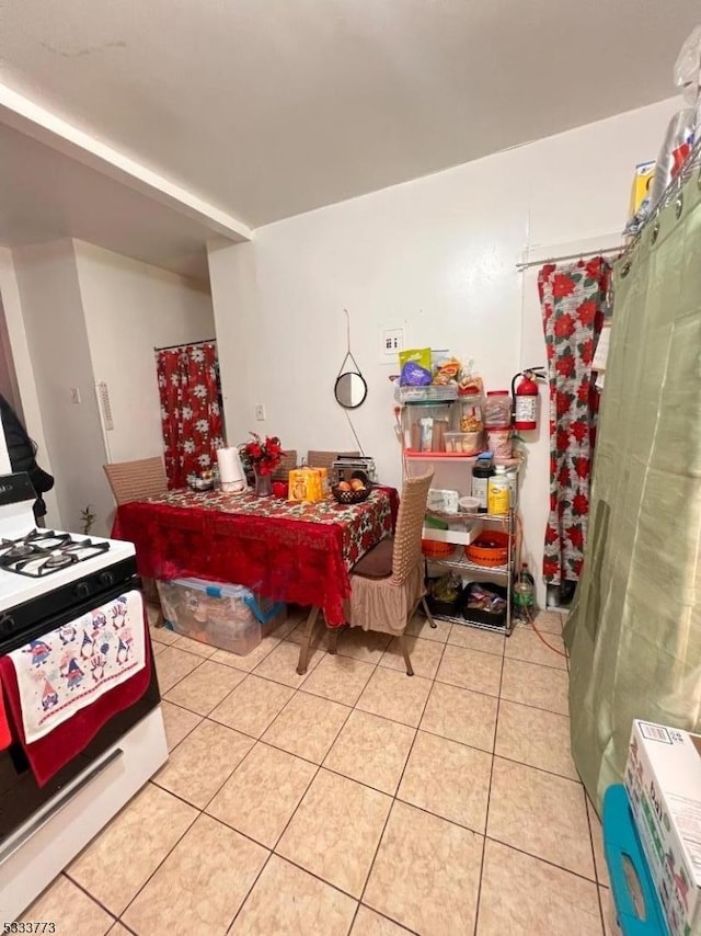 kitchen with light tile patterned floors and gas stove