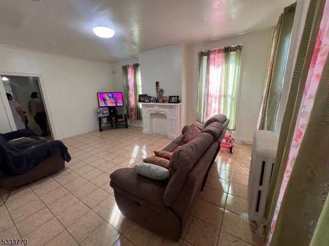 tiled living room with radiator heating unit