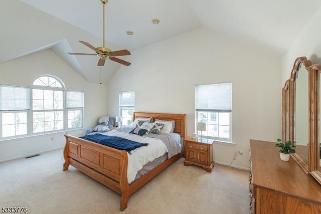 bedroom with high vaulted ceiling, light colored carpet, and ceiling fan