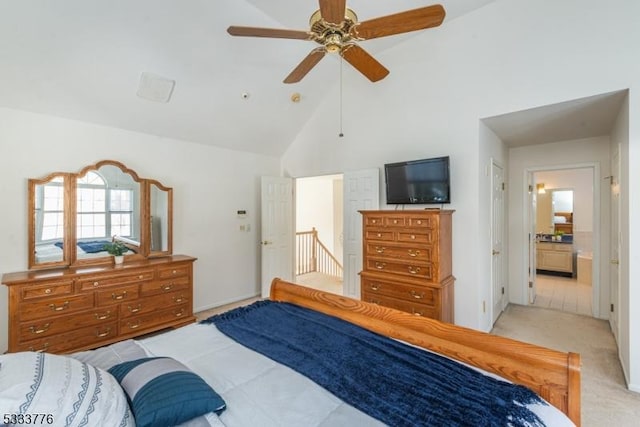 carpeted bedroom featuring high vaulted ceiling, ceiling fan, and ensuite bath