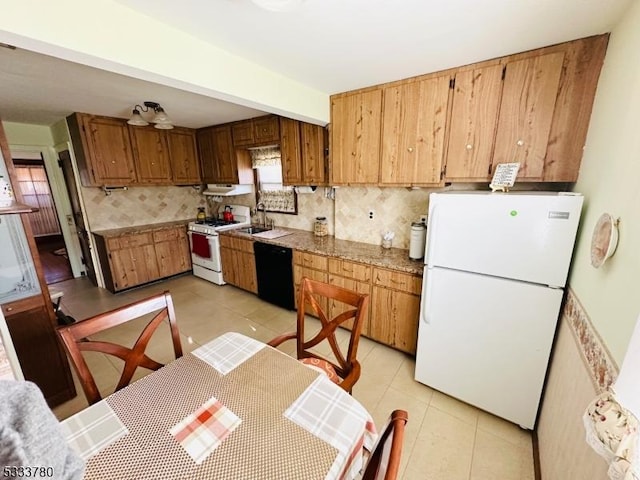 kitchen featuring tasteful backsplash, white appliances, sink, and light tile patterned floors