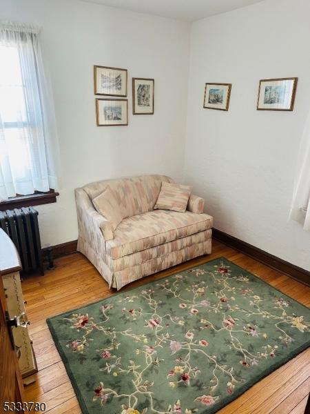 living room featuring radiator and hardwood / wood-style flooring