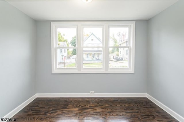 unfurnished room featuring dark hardwood / wood-style flooring