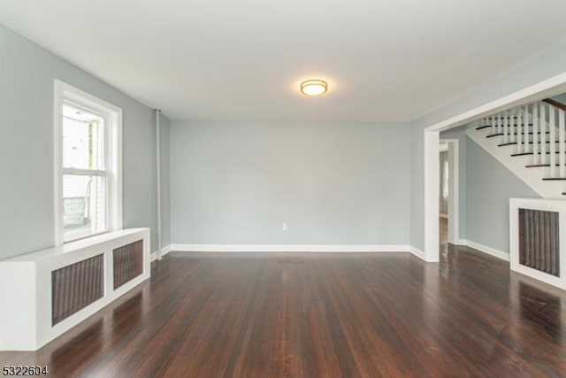 unfurnished living room with dark hardwood / wood-style floors