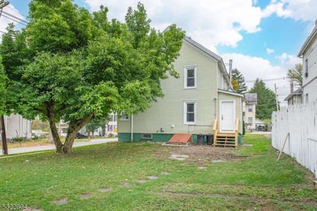 rear view of house with a lawn