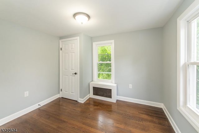 unfurnished room with dark hardwood / wood-style floors