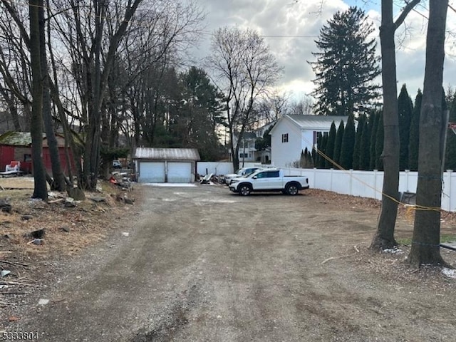 view of yard featuring a garage and an outdoor structure