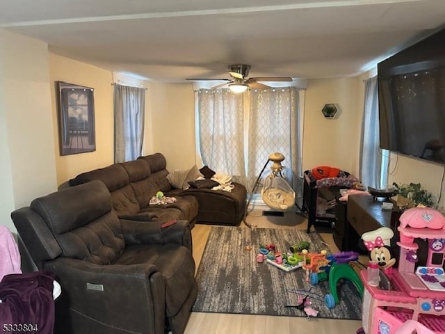 living room featuring wood-type flooring and ceiling fan