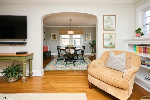 dining room with hardwood / wood-style flooring and ornamental molding