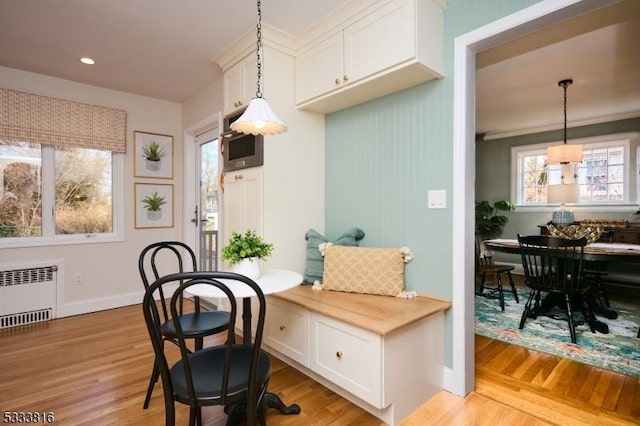 dining space featuring radiator and light hardwood / wood-style floors