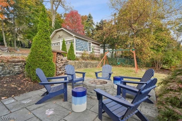 view of patio / terrace with a playground and an outdoor fire pit