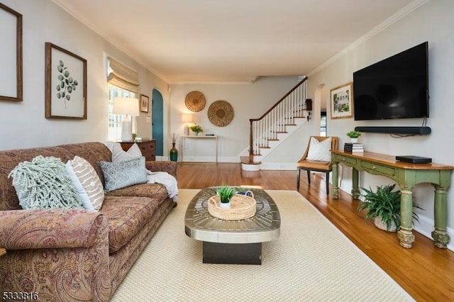 living room with ornamental molding and wood-type flooring