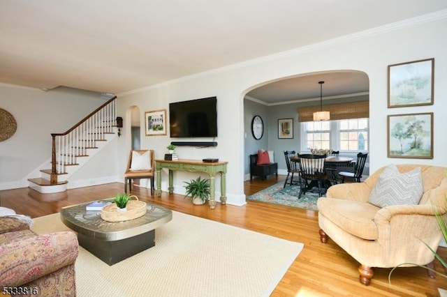 living room with crown molding and hardwood / wood-style floors