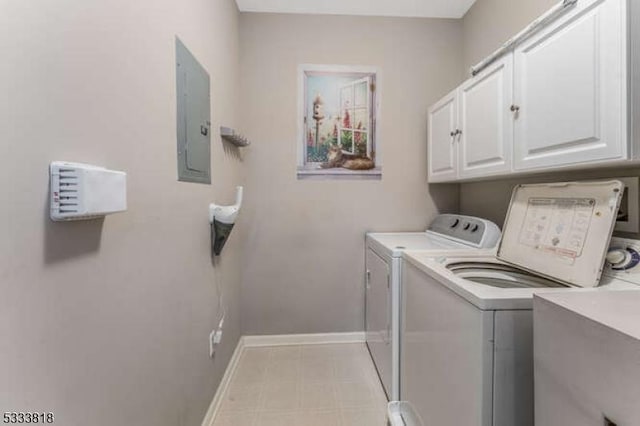 laundry room with cabinet space, electric panel, baseboards, and separate washer and dryer