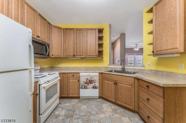 kitchen featuring stone finish flooring, white appliances, a sink, light countertops, and open shelves