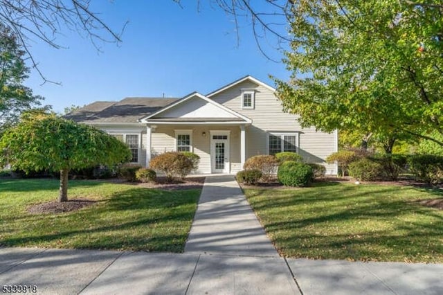 bungalow-style home featuring covered porch and a front lawn