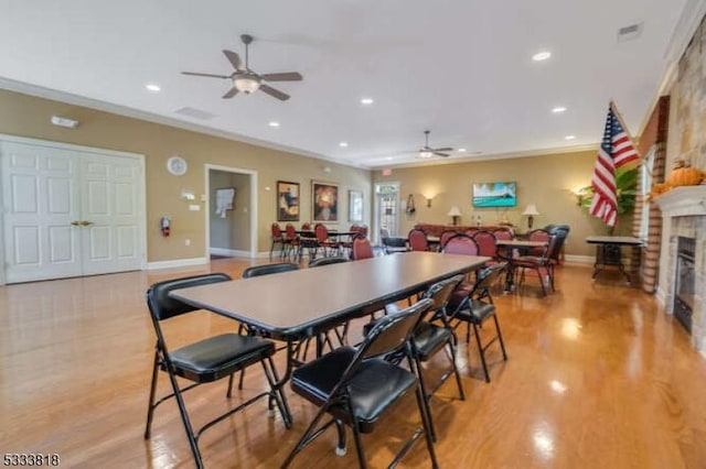 dining area with recessed lighting, a fireplace, light wood finished floors, and baseboards