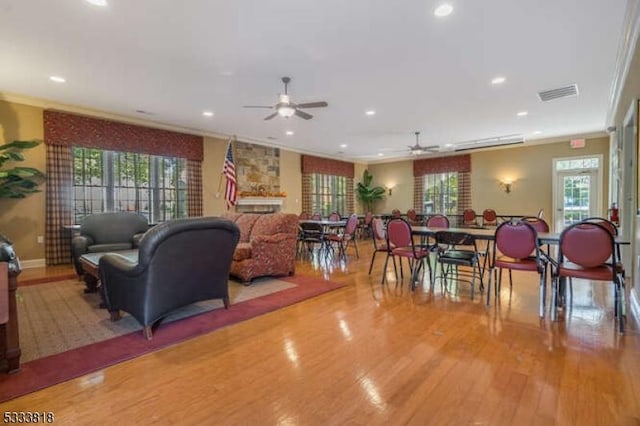 living room featuring a healthy amount of sunlight, light wood-style flooring, visible vents, and recessed lighting