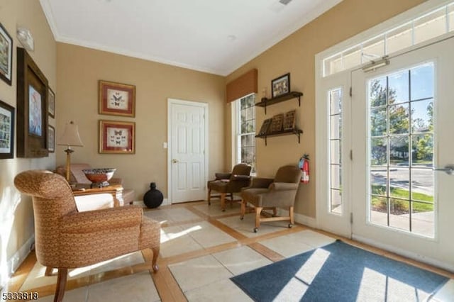 sitting room with ornamental molding, a wealth of natural light, and baseboards