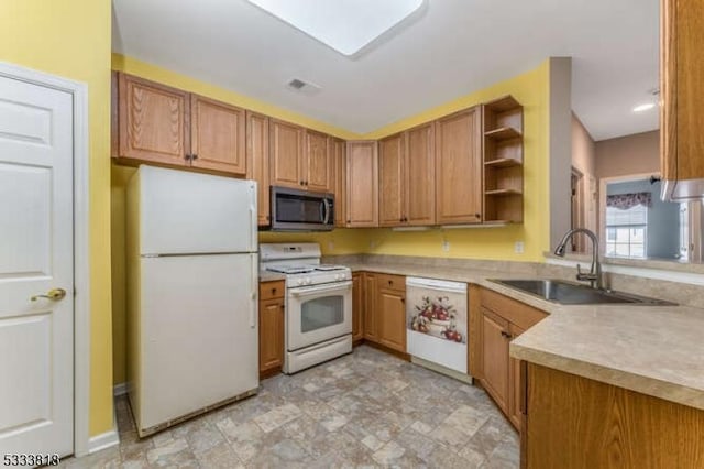 kitchen featuring open shelves, light countertops, brown cabinetry, a sink, and white appliances