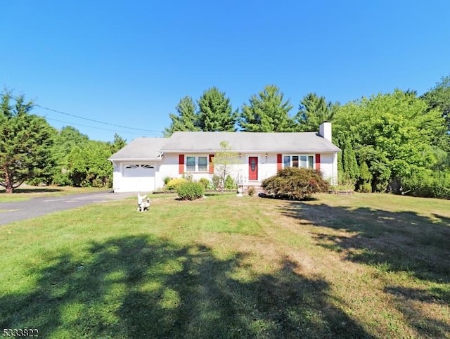 ranch-style home with a garage and a front lawn