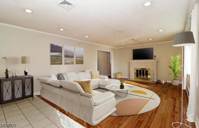 living room featuring ornamental molding and light hardwood / wood-style floors