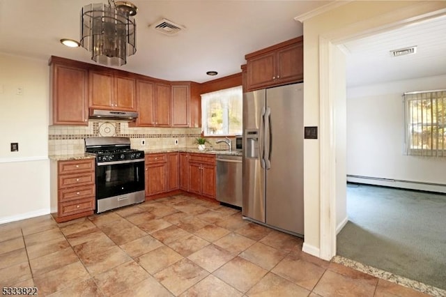 kitchen with sink, light stone counters, crown molding, stainless steel appliances, and backsplash