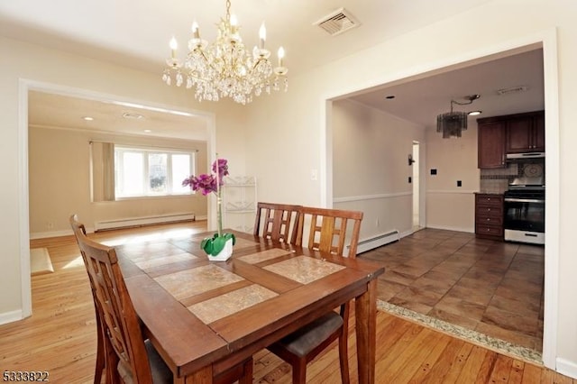 dining area featuring light hardwood / wood-style flooring and baseboard heating