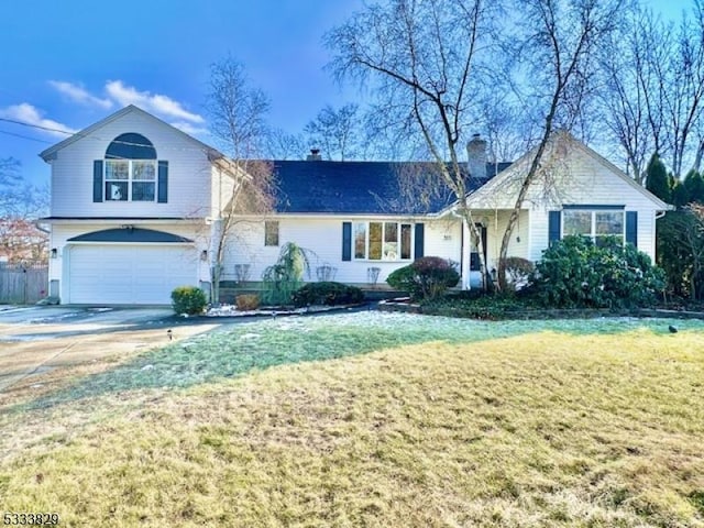 view of front facade featuring a garage and a front lawn