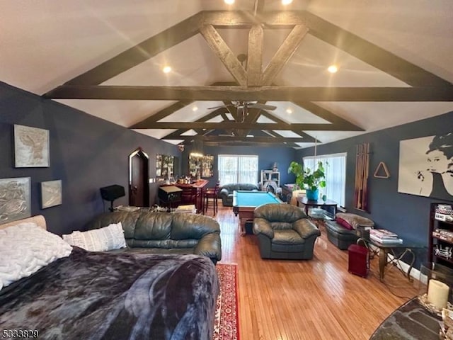 bedroom featuring hardwood / wood-style floors and vaulted ceiling with beams