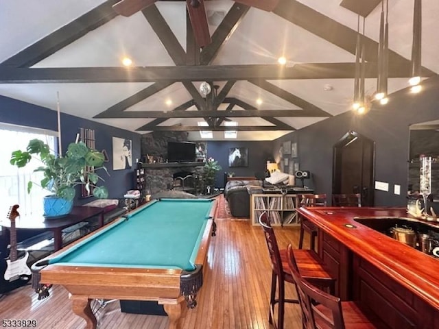 playroom featuring light wood-type flooring, wet bar, billiards, and lofted ceiling with beams