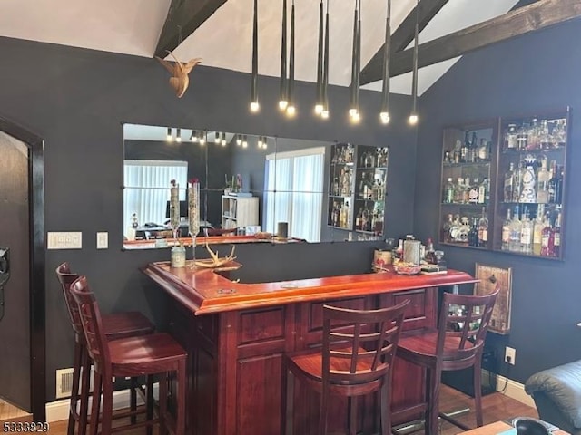 bar featuring hardwood / wood-style floors and lofted ceiling with beams