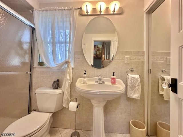 bathroom featuring toilet, tile walls, tile patterned floors, and walk in shower