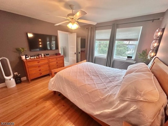 bedroom with ceiling fan and hardwood / wood-style flooring