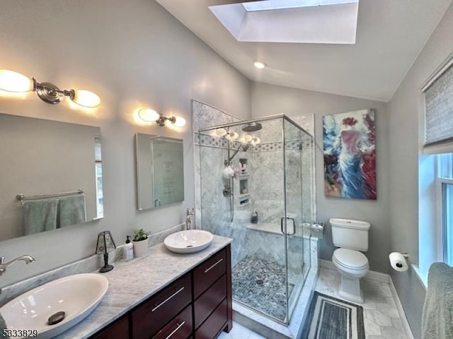 bathroom featuring vaulted ceiling with skylight, toilet, walk in shower, and vanity