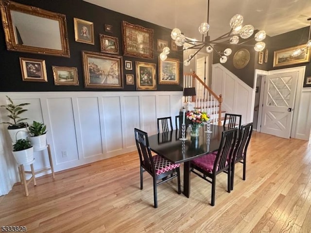 dining area with a chandelier and light hardwood / wood-style flooring