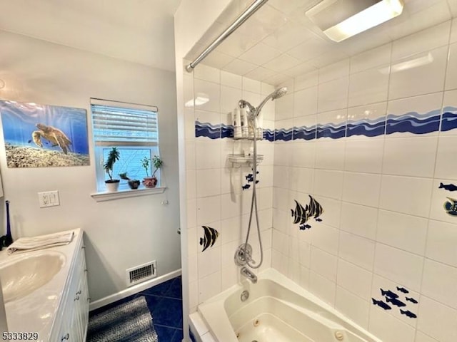 bathroom featuring tiled shower / bath combo, tile patterned floors, and vanity