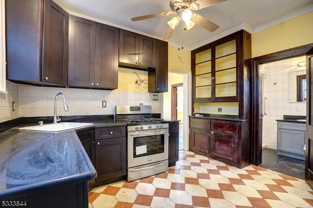 kitchen featuring sink, stainless steel gas stove, tasteful backsplash, dark brown cabinetry, and ornamental molding