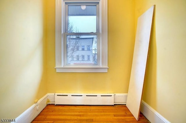 interior space with hardwood / wood-style flooring and a baseboard radiator