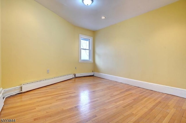 spare room with light hardwood / wood-style flooring and baseboard heating