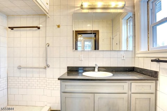 bathroom with vanity, backsplash, and tile walls