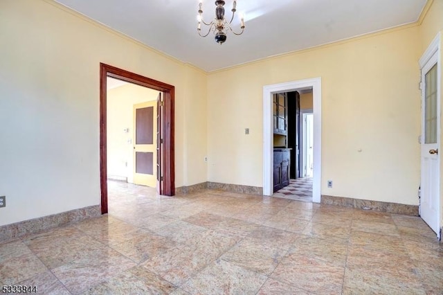 spare room featuring ornamental molding and a chandelier