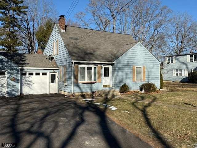 view of front of property with a garage and a front yard