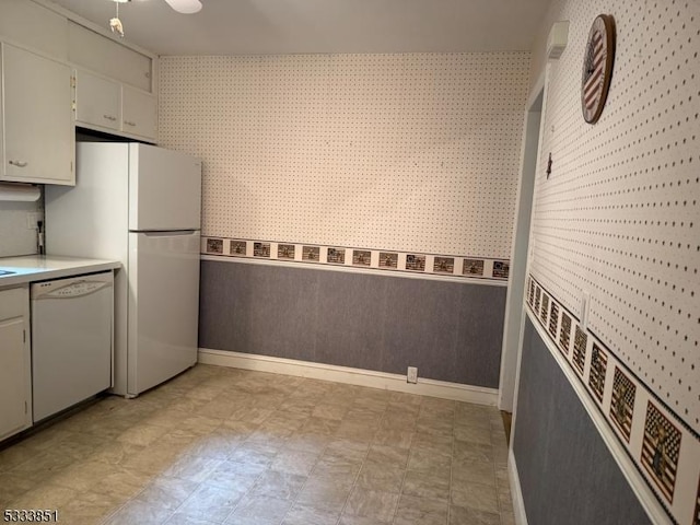 kitchen featuring white cabinetry and white appliances